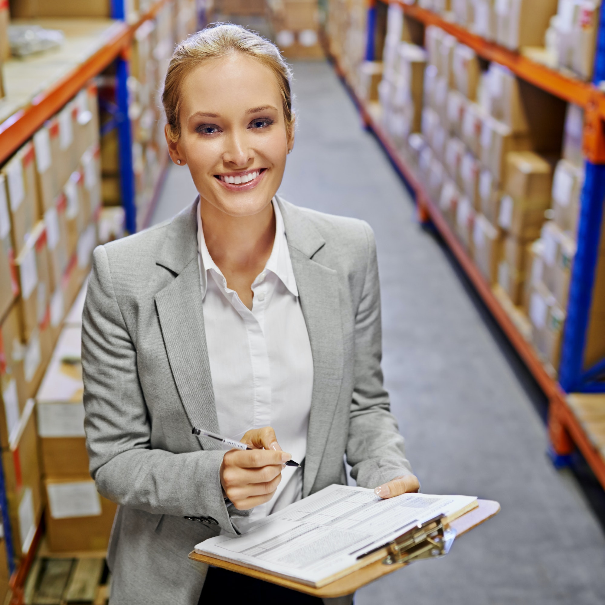 Your order status Delivered. Portrait of a woman at work in a storage warehouse.